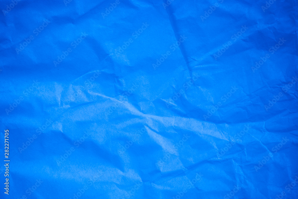 Fototapeta premium Crumpled blue paper background.