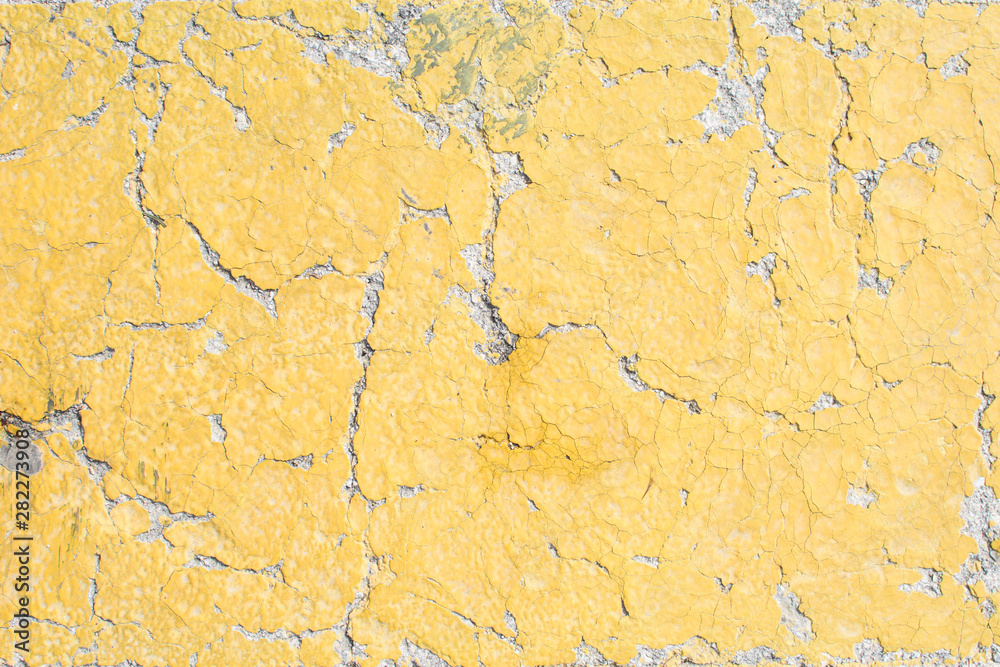 Fototapeta premium Yellow cracked paint.