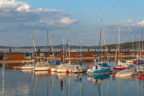 Boat station with yachts on Lake Brombach in the evening at sunset