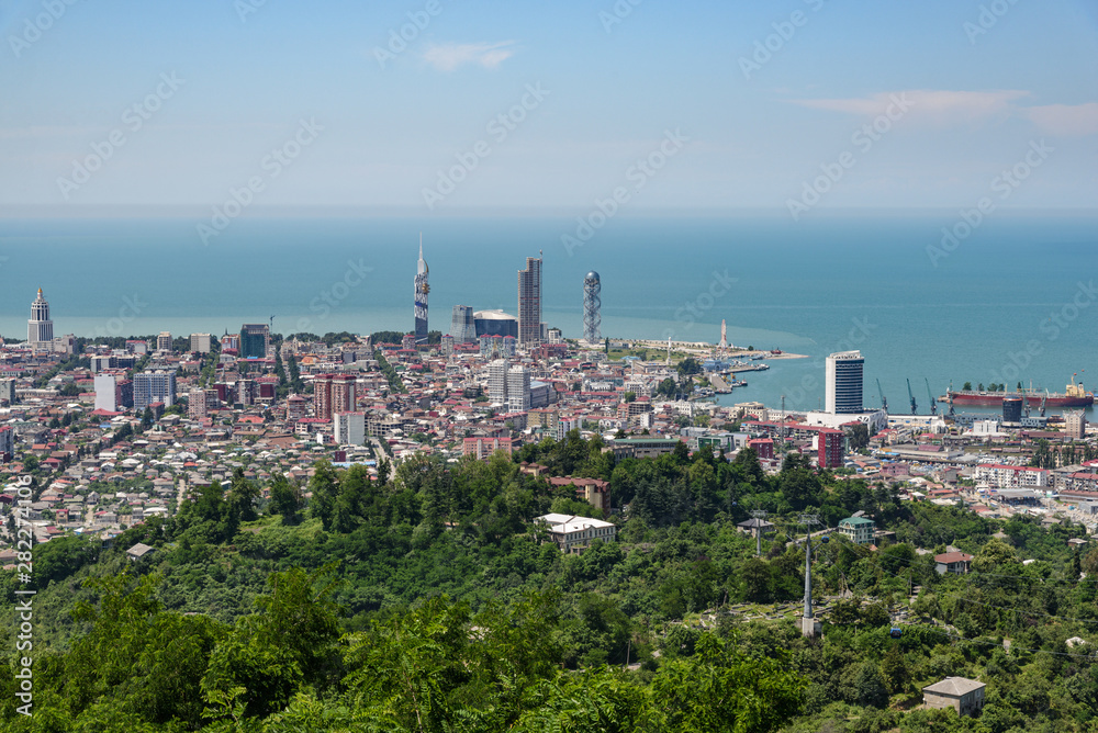 view of the resort city of Batumi from the height of the observation deck, on a bright sunny day, with clouds in the sky.