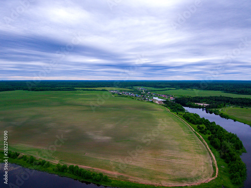 aerial view of a village, field and pond