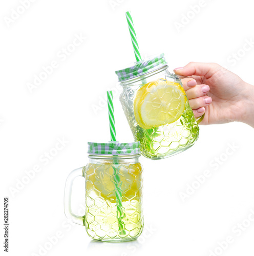 Mason jar glass with lemon water in hand on white background isolation