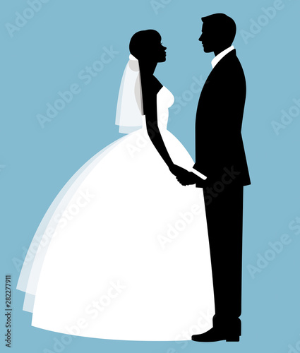 Silhouette of a loving couple of newlyweds groom and bride in full length in wedding dresses