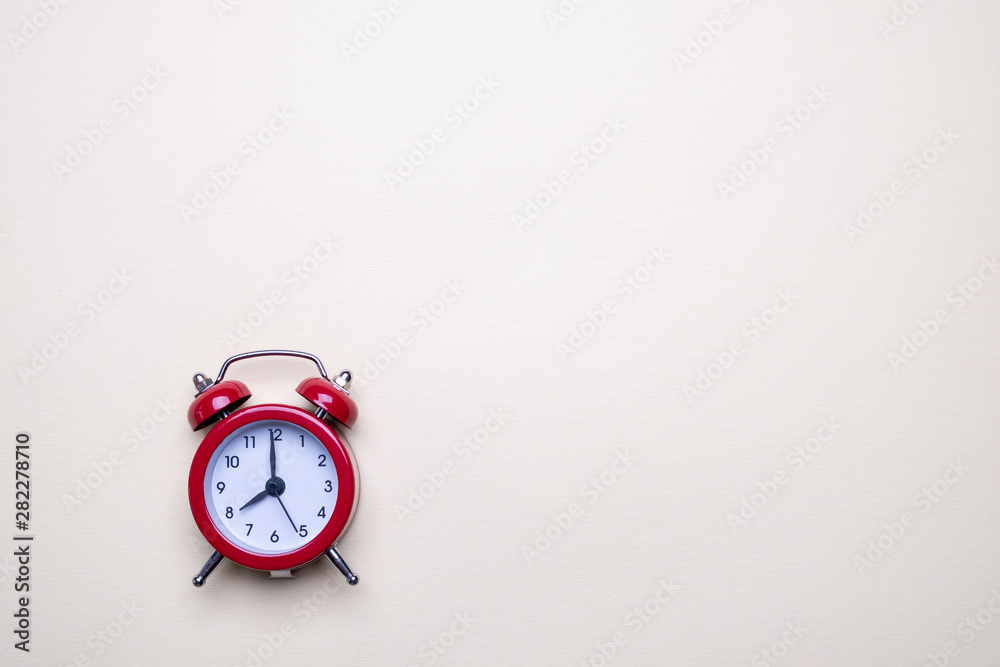 Red alarm clock on light pastel background. Blank note for text. Reminder. Space for copy. Minimal concept. Red alarm clock on light pastel background. Blank note for text. Reminder. Space for copy. Minimal concept.