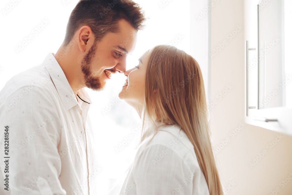 Loving couple have fun at home. Pretty blonde in a white blouse. Loving couple have fun at home. Pretty blonde in a white blouse.