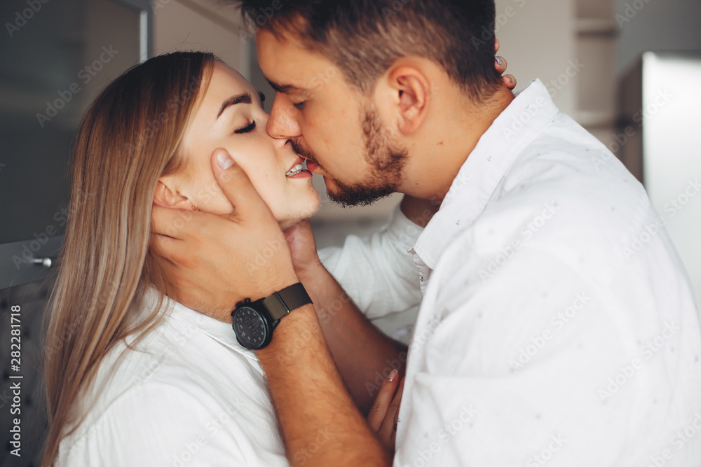 Loving couple have fun at home. Pretty blonde in a white blouse. Loving couple have fun at home. Pretty blonde in a white blouse.