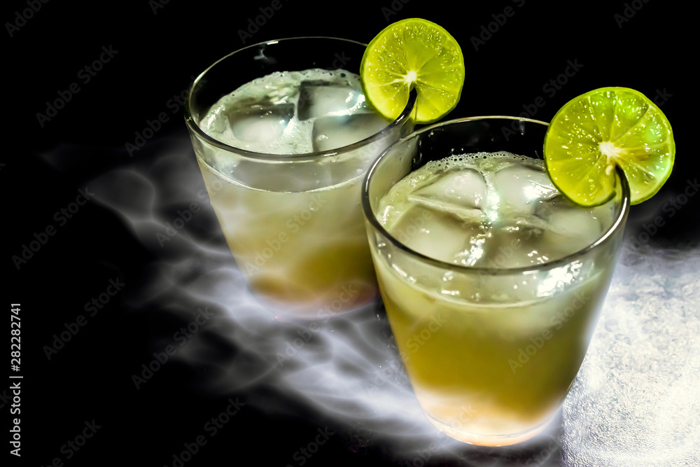 Two glasses of lemon juices with ices, and smoke effect Two glasses of lemon juices with ices, and smoke effect