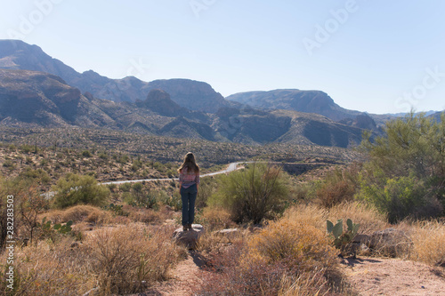 woman overlooking view over the desert at apache trail america arizona photo