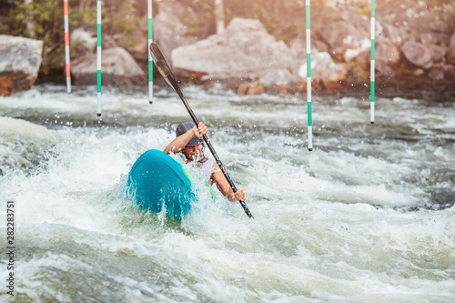 Fototapeta Naklejka Na Ścianę i Meble -  Guy in kayak sails mountain river. Whitewater kayaking, extreme sport rafting