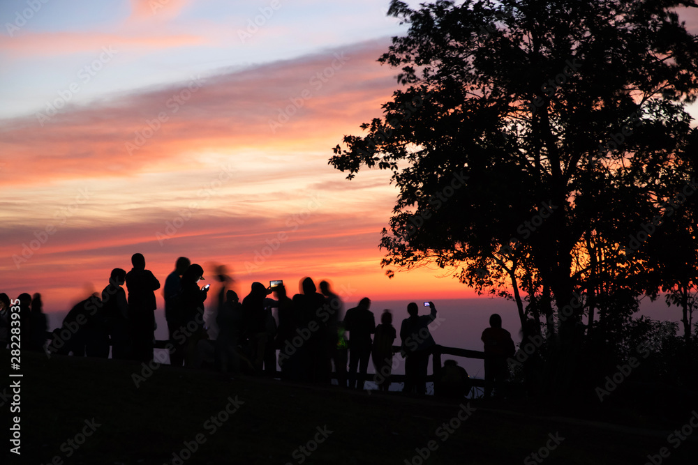 Dramatic landscape of silhouette people taking photo with beautiful sunrise at the peak of Phu Ruea National Park in Loei Province, Thailand. Dramatic landscape of silhouette people taking photo with beautiful sunrise at the peak of Phu Ruea National Park in Loei Province, Thailand.