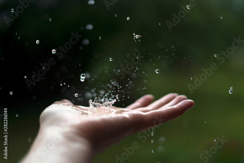 Hand catching raindrops.