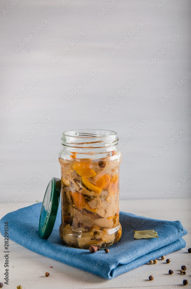 pickled mushrooms in a glass jar on a white background pickled mushrooms in a glass jar on a white background