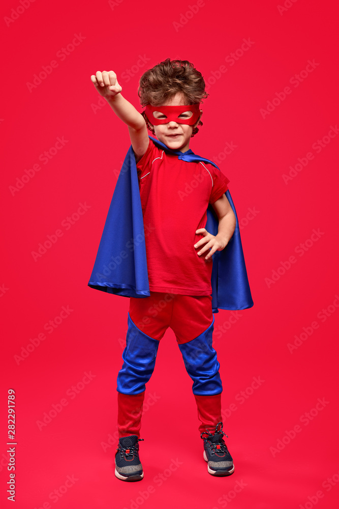 Little superhero in heroic pose