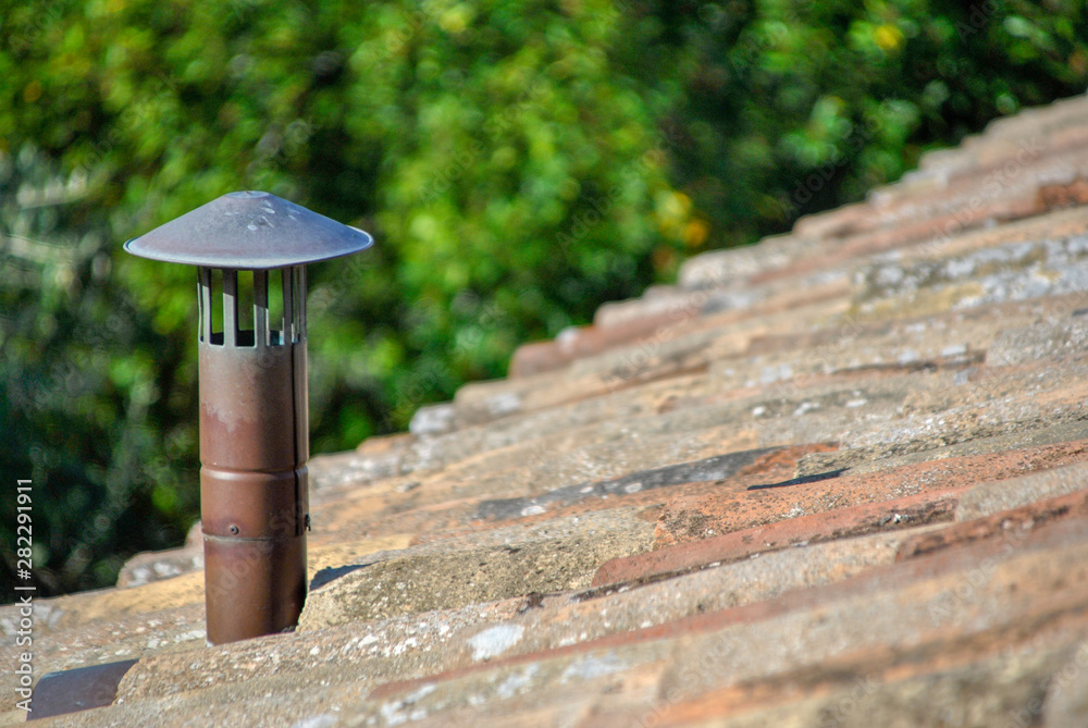 tiles on a roof top with a chimney tiles on a roof top with a chimney