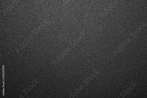 Texture of black matte plastic.Black and white matte background.The background is black rough plastic.