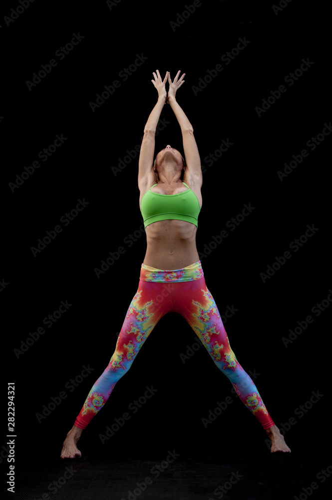 Sexy Mature Woman stretching up Full Body in colorful neon yoga pants.  Stock-Foto | Adobe Stock