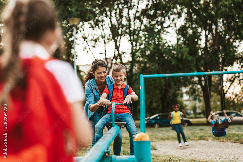 School children playing on the seesaw.