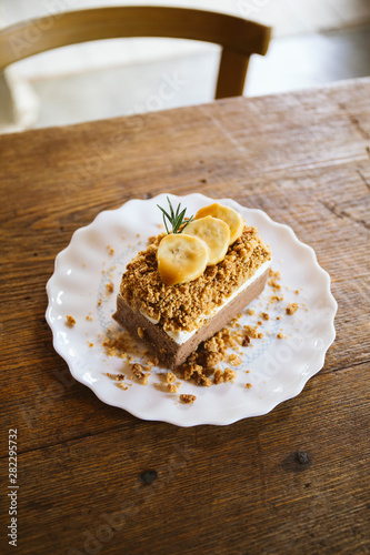 Banana caramel and hazelnut cake on wood table