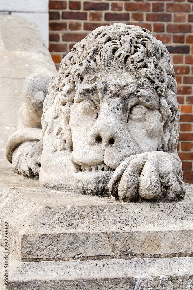 Sculpture of sleeping lion in front of Town Hall at Market Square (Krakow, Poland)