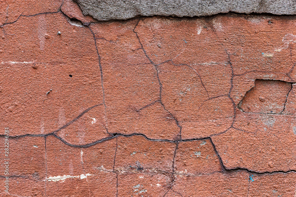 Obraz premium Old red cracked wall, rustic texture, design background.