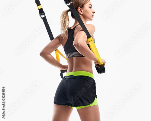 Woman exercising with suspension trainer © kegfire