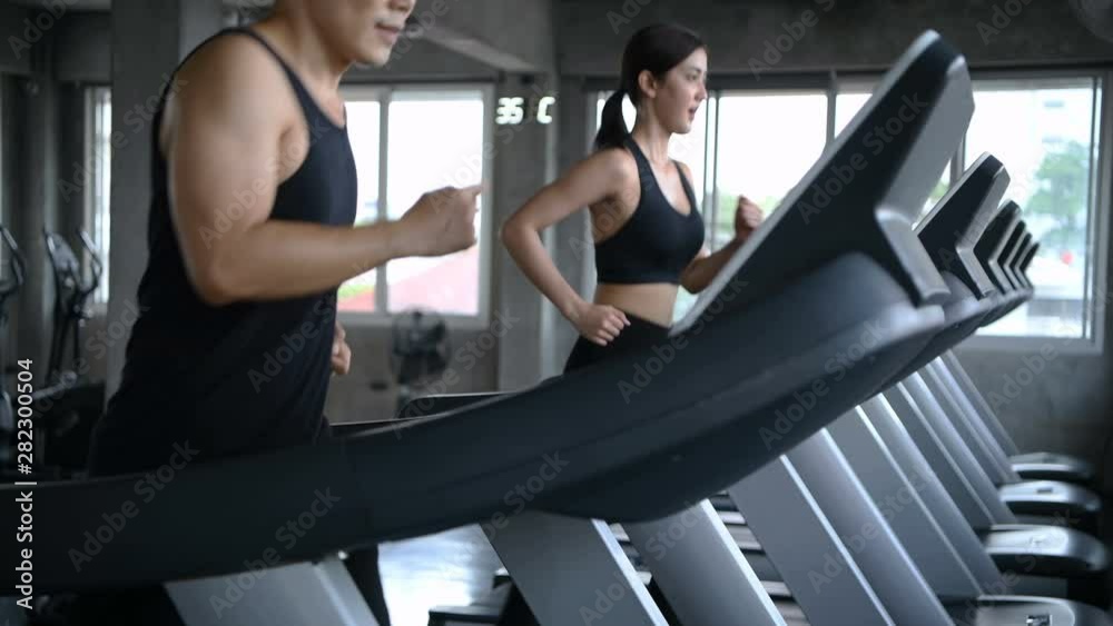 Sports concept. Men and women are running together at the fitness center. Sports concept. Men and women are running together at the fitness center.