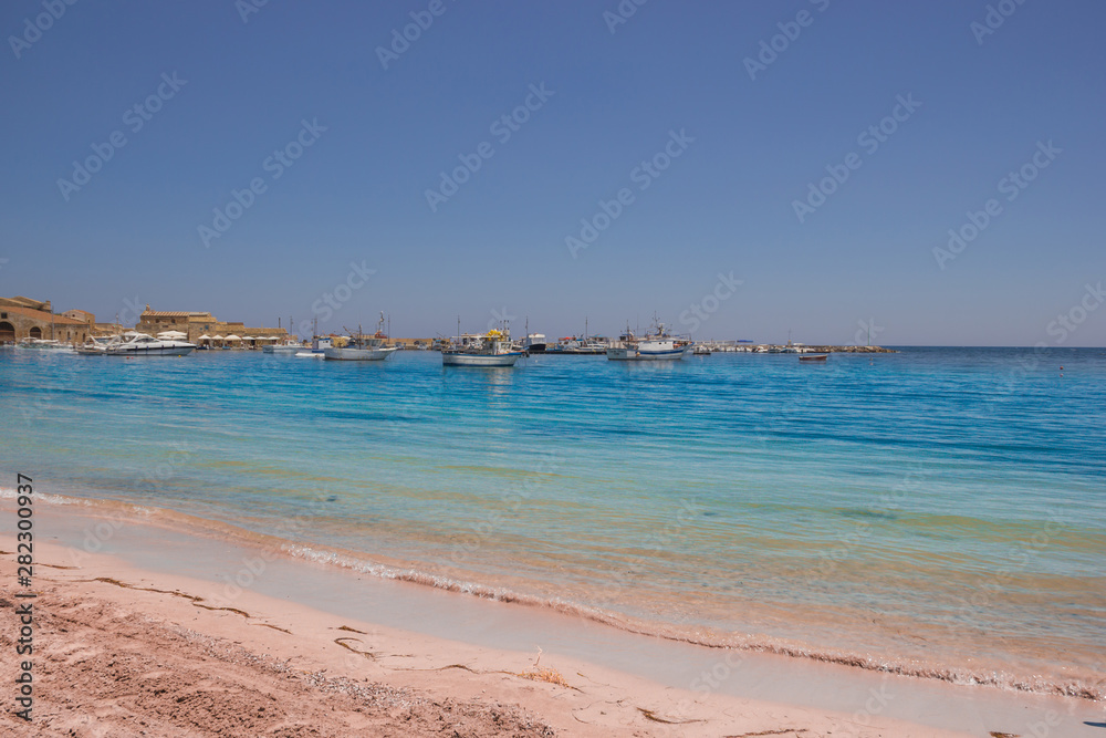 Marzamemi Sicily, view of the famous tourist village from the seaside promenade and beach in a Summer day