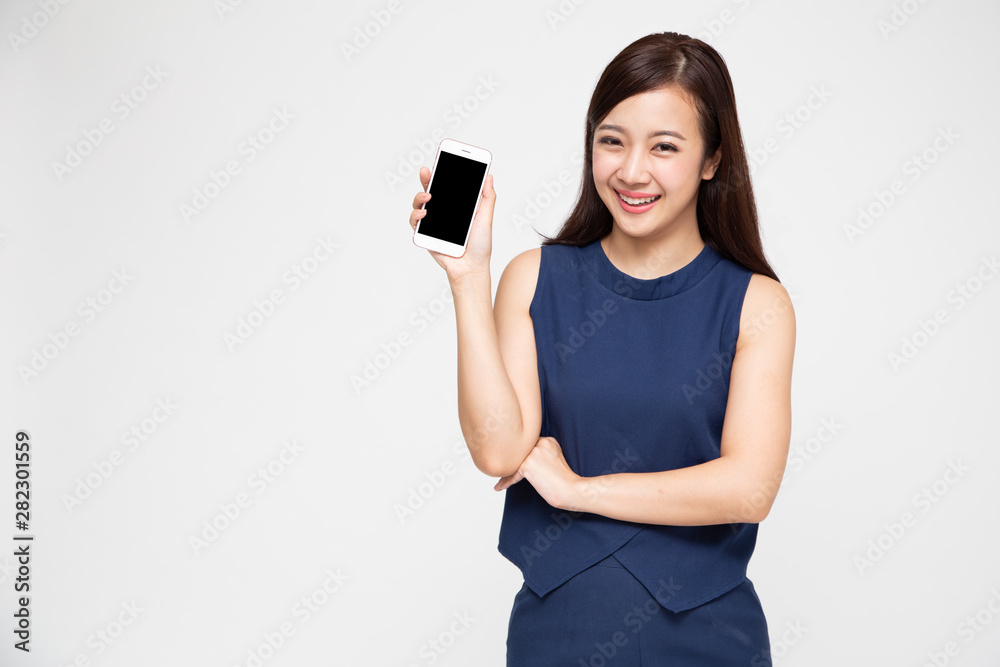 Portrait of beautiful Asian wowan showing or presenting mobile phone application on hand isolated over white background Portrait of beautiful Asian wowan showing or presenting mobile phone application on hand isolated over white background