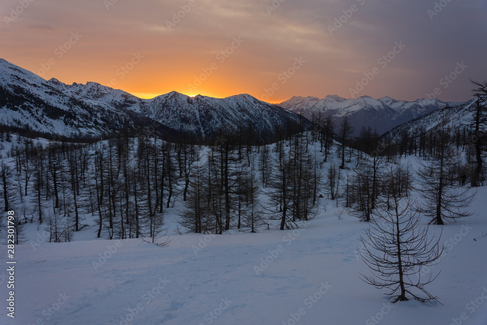 Snowy panorama of the Val Bognanco that opens behind Domodossola at the dawn, Piedmont