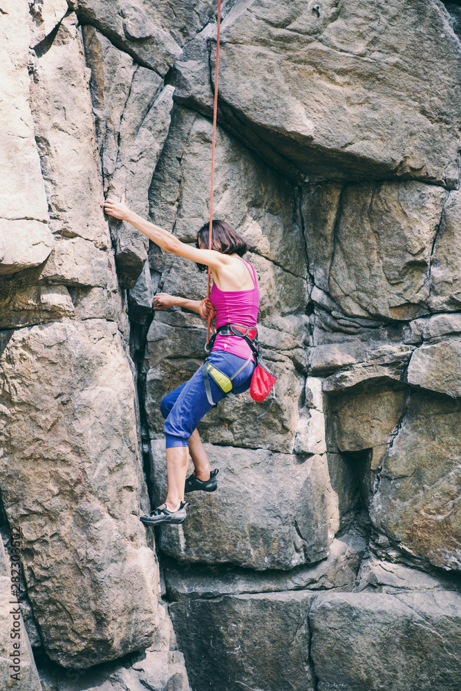 Rock climber is training on natural terrain. Rock climber is training on natural terrain.
