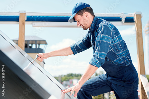 Young contemporary technician of customer service repairing handle © pressmaster