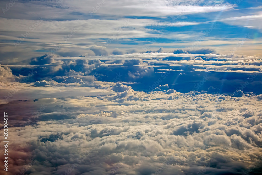 Naklejka premium fluffy clouds from the plane window in flight.
