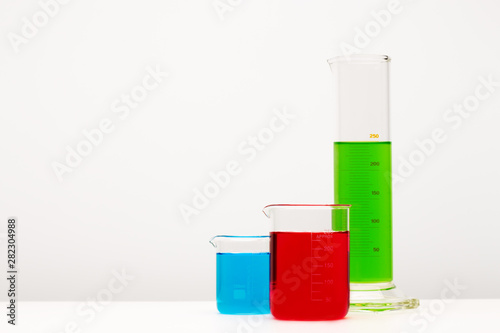 Group of laboratory glassware brightly colored liquid. Science concept.