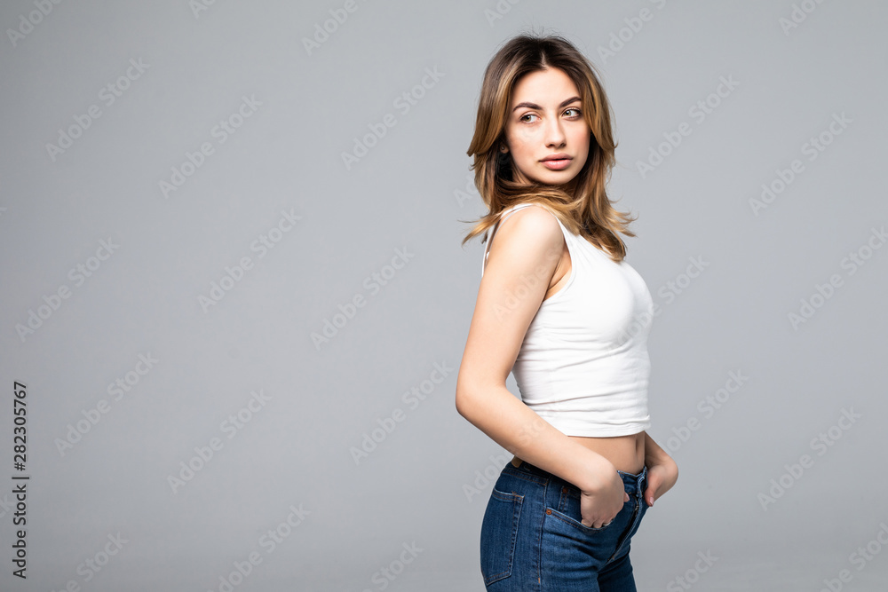 Photo of happy woman smiling and standing isolated over gray background Photo of happy woman smiling and standing isolated over gray background
