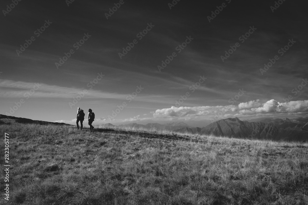 idyllic landscape at Monte Tamaro in Switzerland - silhouette of people