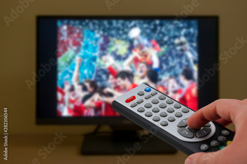 Sports television remote control in the hand, zapping