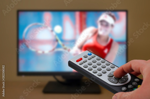 Sports television remote control in the hand, zapping