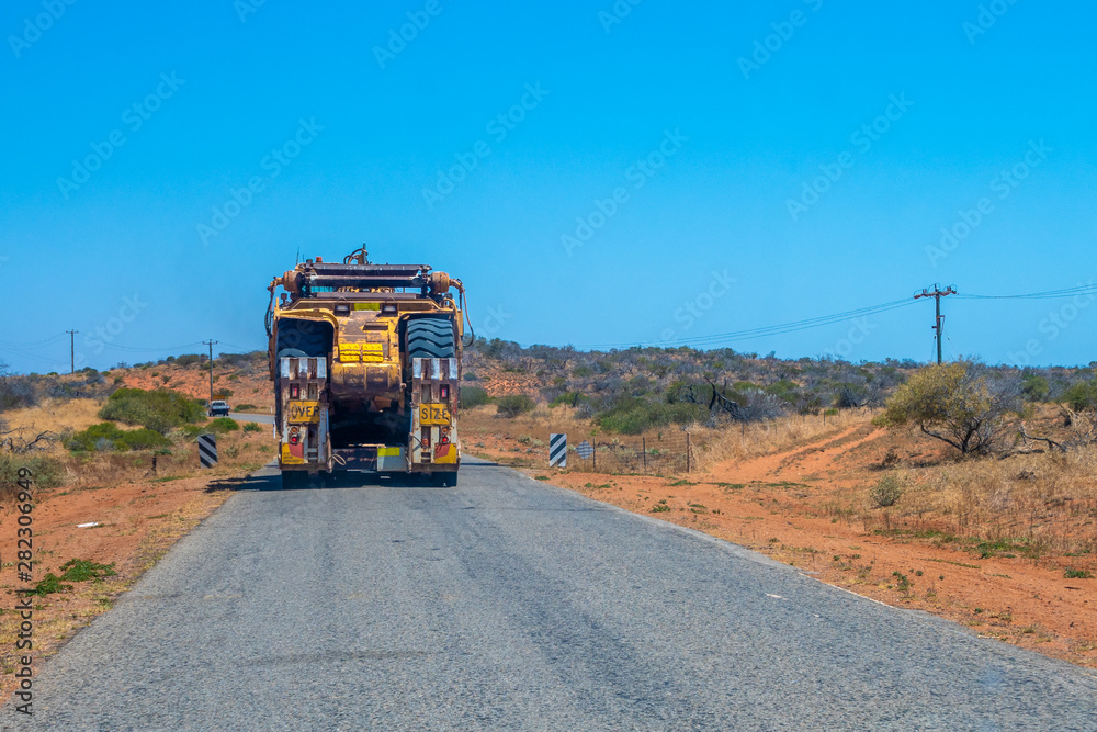 Road Train oversize transport in Australia transporting big mining equipment