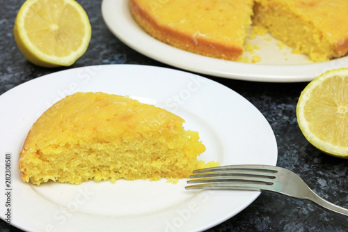 Homemade Slice Of Lemon Drizzle Cake On A Plate.