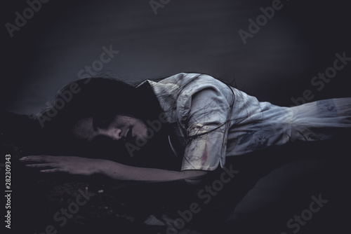 Portrait of asian woman make up ghost face at the swamp,Horror scene,Scary background,Halloween poster,Thailand people