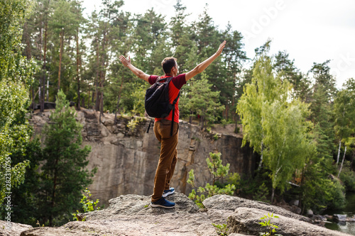 Man Traveler with backpack hiking Travel Lifestyle concept beautiful mountains landscape on background Summer vacations activity outdoor © Angelov