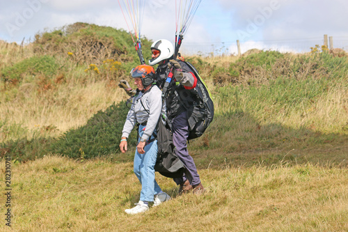 Tandem paraglider launching