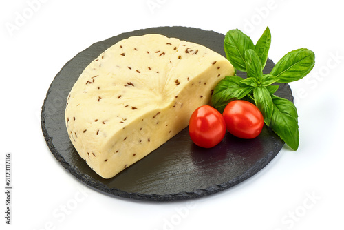 Sliced Cheese with cumin seeds on a stone plate, isolated on white background