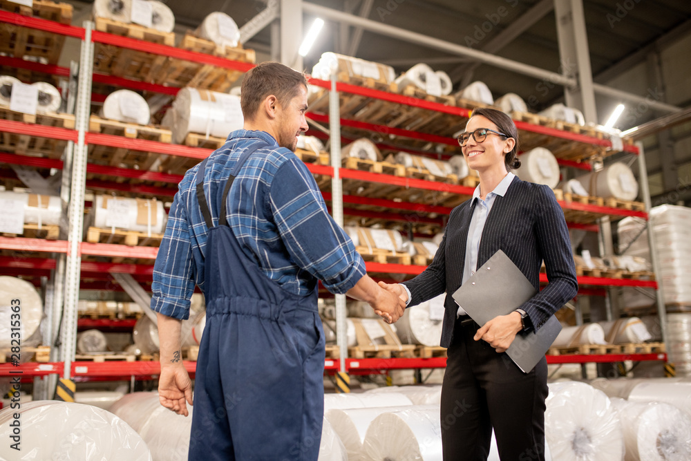 Two young successful business partners shaking hands after negotiating Two young successful business partners shaking hands after negotiating