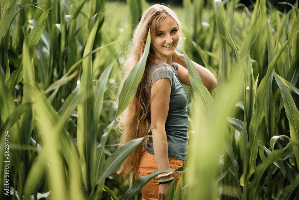 beautiful young girl walks through a corn field, woman portrait outdoors beautiful young girl walks through a corn field, woman portrait outdoors