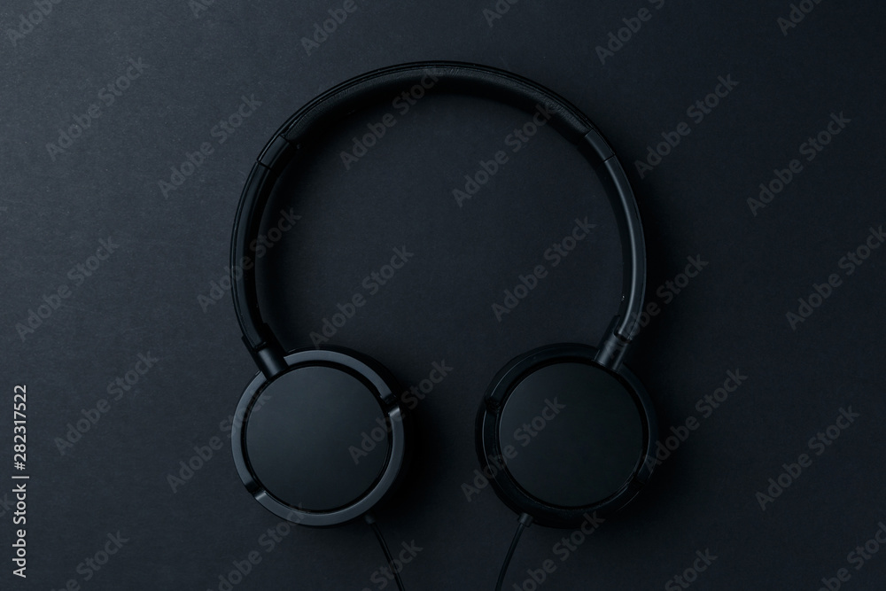Headphone. Music concept. Flat lay: headphones on black background. Top view. Trendy colorful photo. Black headphones on yellow background. Music concept. Minimal style Headphone. Music concept. Flat lay: headphones on black background. Top view. Trendy colorful photo. Black headphones on yellow background. Music concept. Minimal style