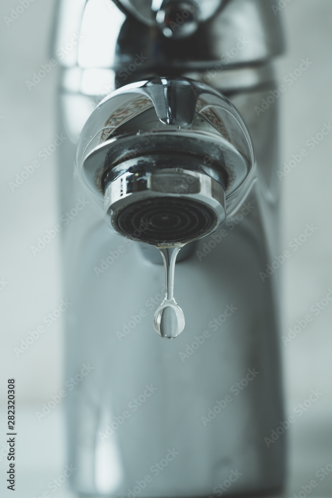 water drop dripping from the tap and water shortage water drop dripping from the tap and water shortage