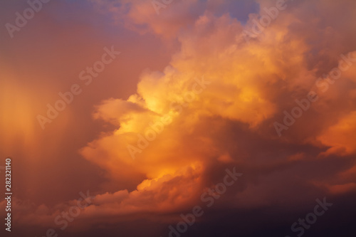 Dramatic bright orange yellow and blue colors of sunset sky