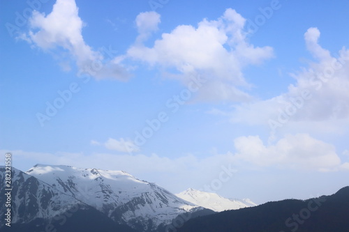 Clouds and snow-capped peaks of the Caucasus Mountains