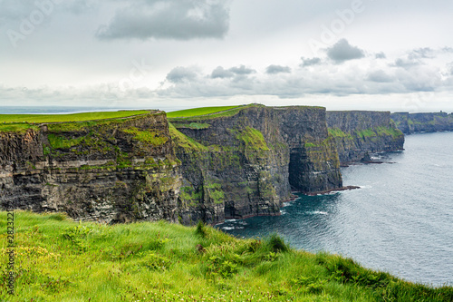 Beautiful Irish landscape of the Cliffs of Moher, geosites and geopark, Wild Atlantic Way, wonderful cloudy spring day in the countryside in county Clare in Ireland